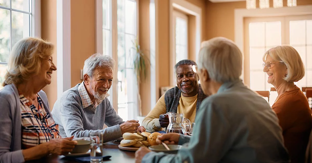 Several older adults gathered at a table.