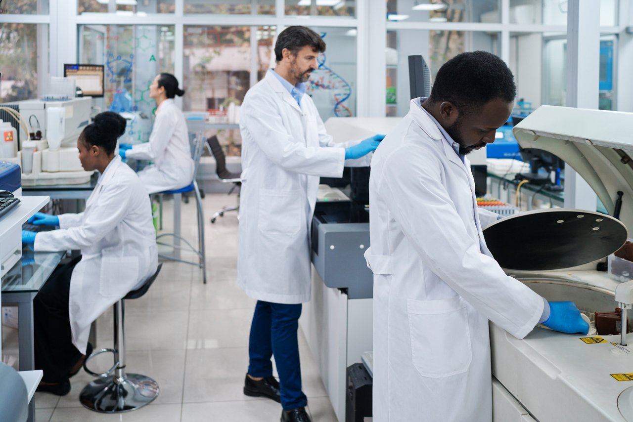 Male and female medical researchers working in laboratory