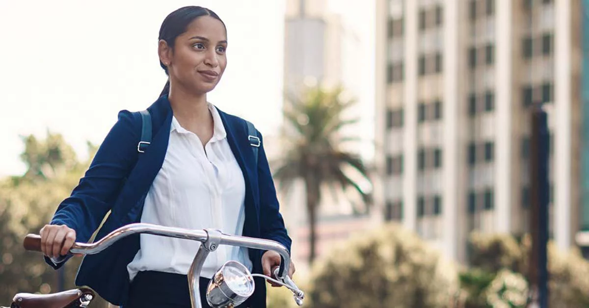 Young woman taking a bicycle to work