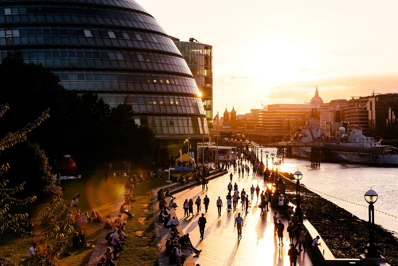 People walking on streets on sunset evening