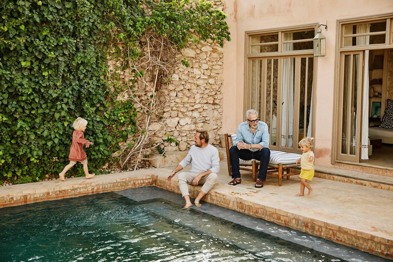 Picture of grandfather and adult son playing with grandchildren