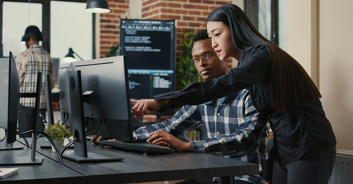 Two people looking at the monitor