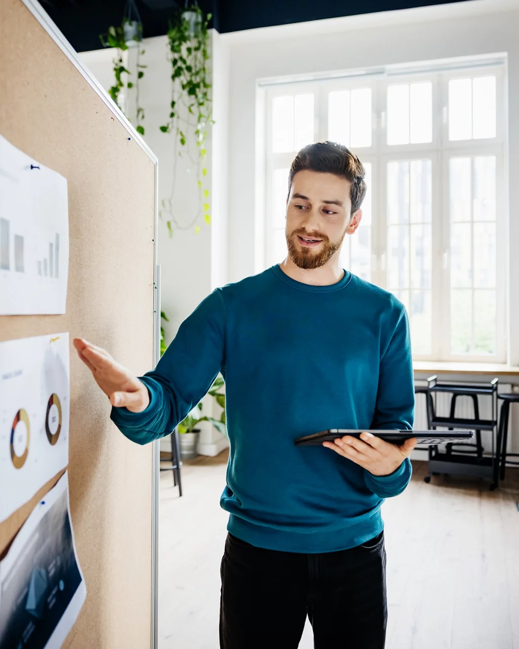 A man looking presentation chart while standing