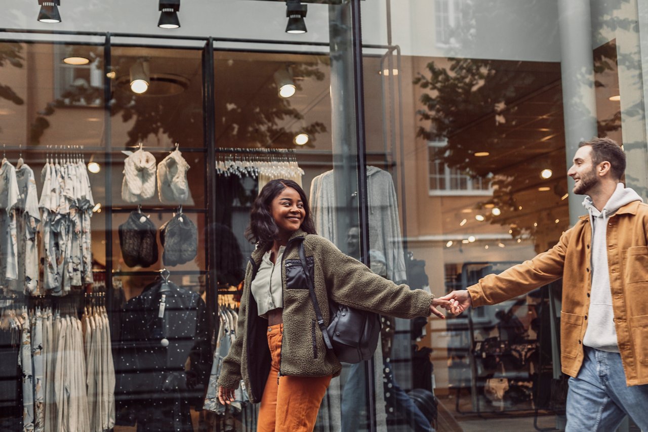 Happy couple walking together in retail shop