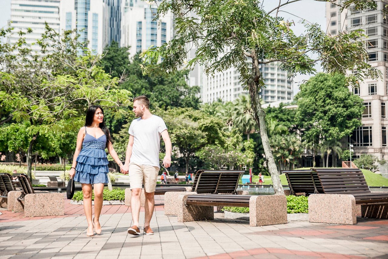 A couple is walking holding hands