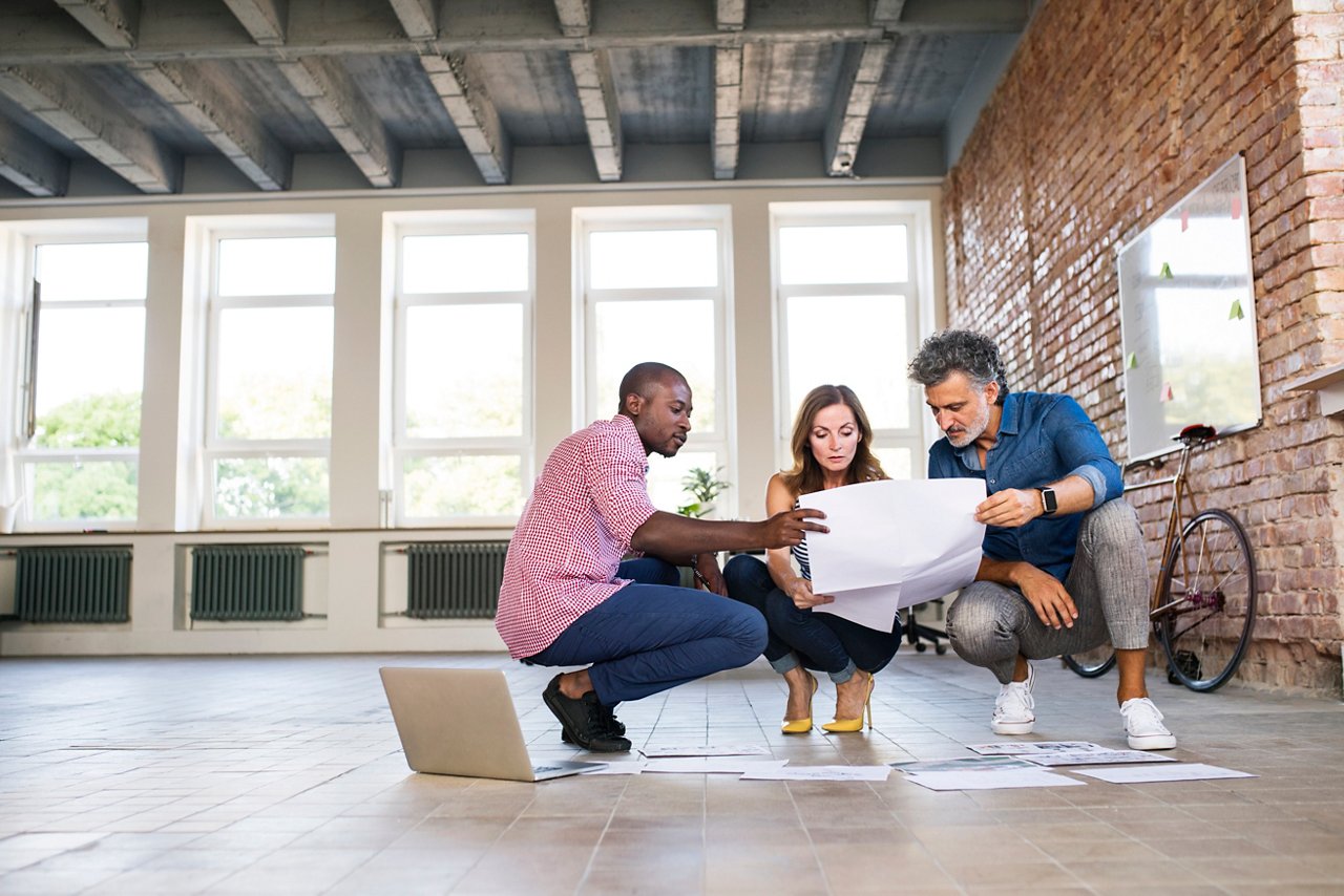 Team of architects discussing the rebuilding of a loft office