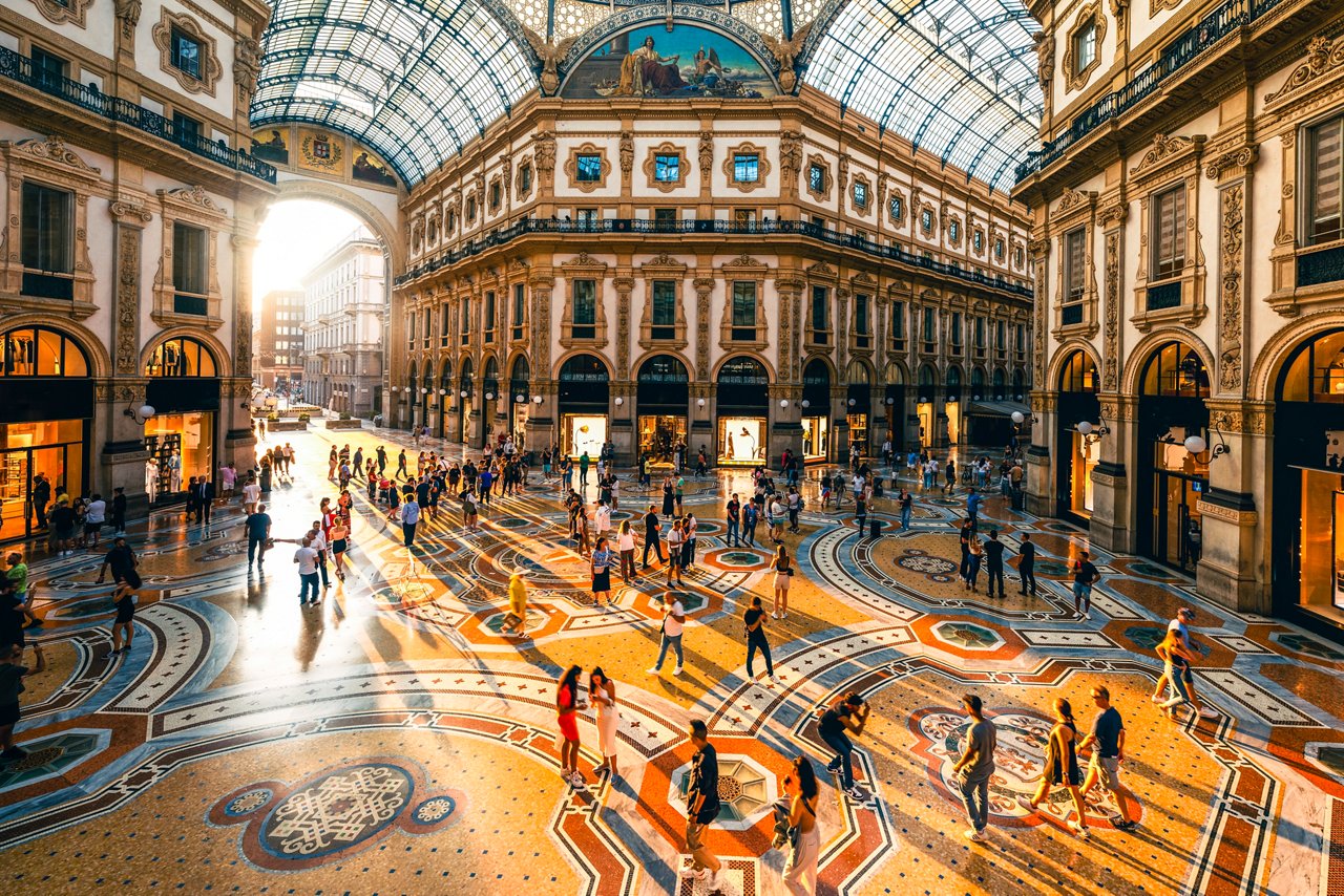 Crowd of people in Galleria Vittorio Emanuele II at sunset, Milan, Italy