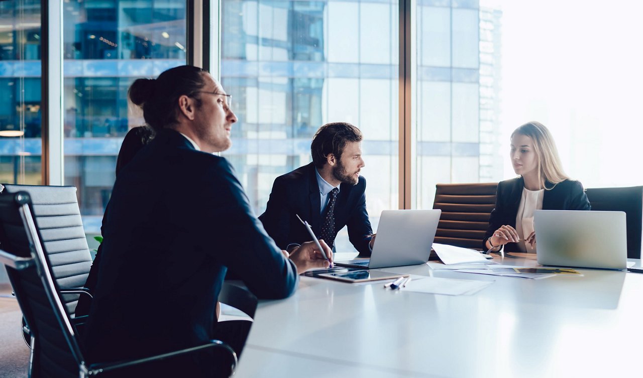 Employees discussing in meeting room