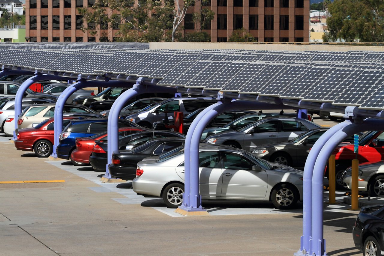 Parking lot featuring solar power panels to shade cars and provide power.
