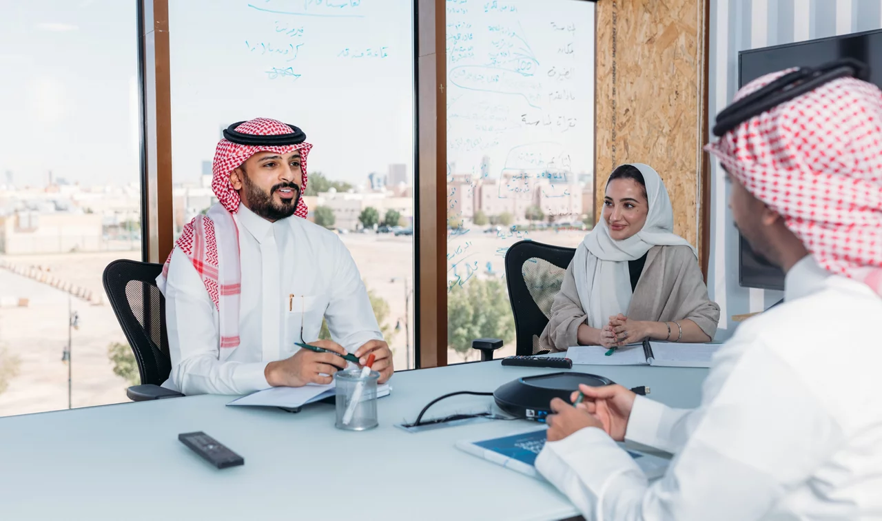 Three people discussing in a office