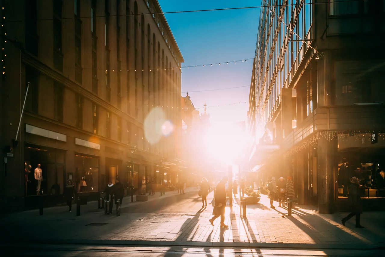 People Walking On Kluuvikatu Street In Winter Sunlight.