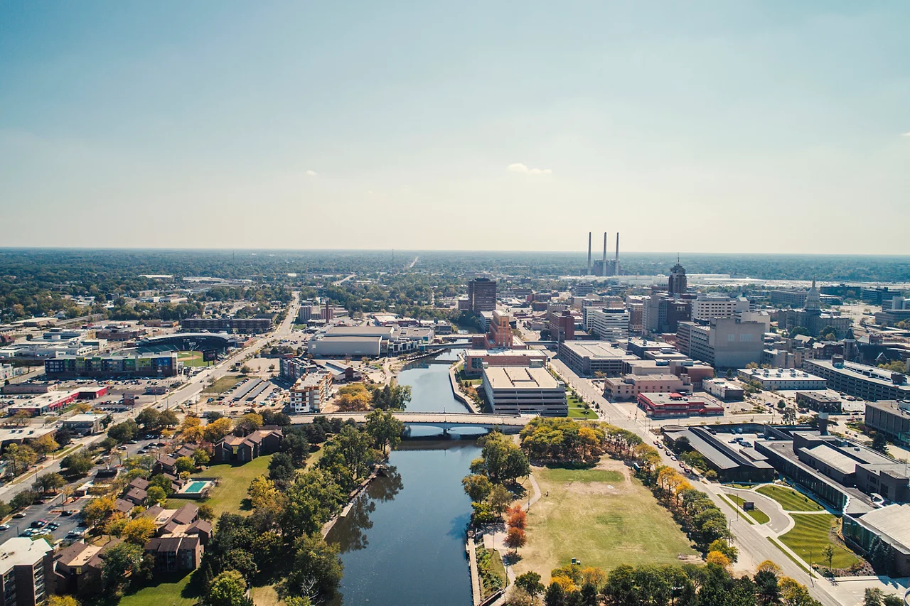 Aerial view of cityscape against sky during sunny day