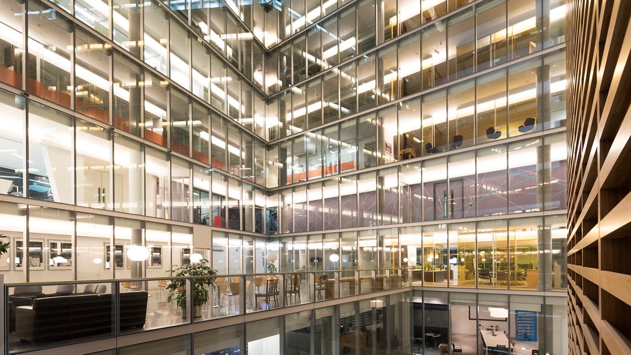 Modern office interior architecture. Internal glass walled atrium at corporate business offices.