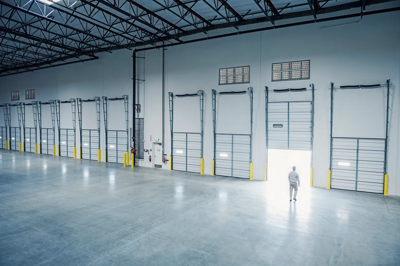 Man in warehouse walking towards door