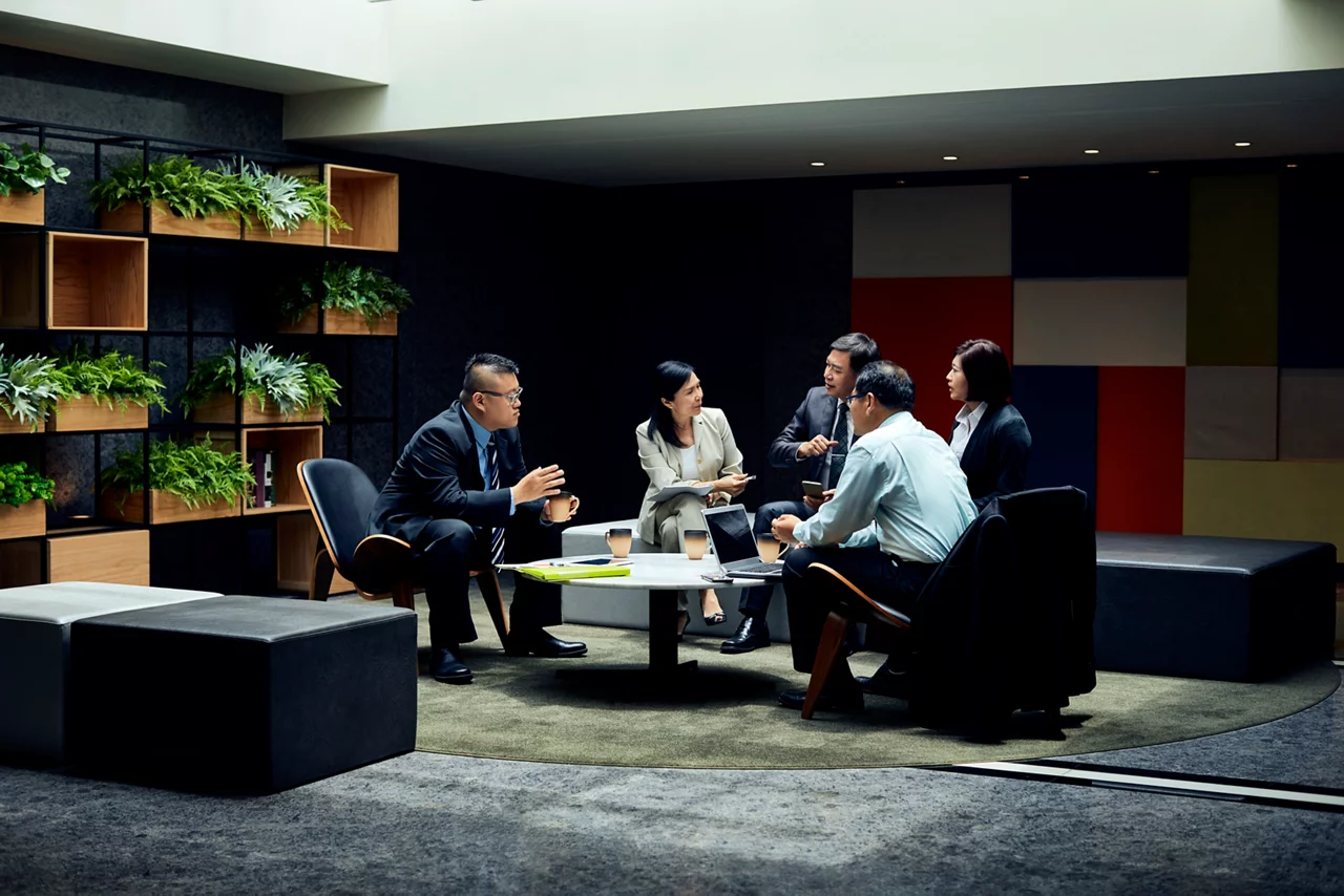 Businessmen and businesswomen discussing during meeting.