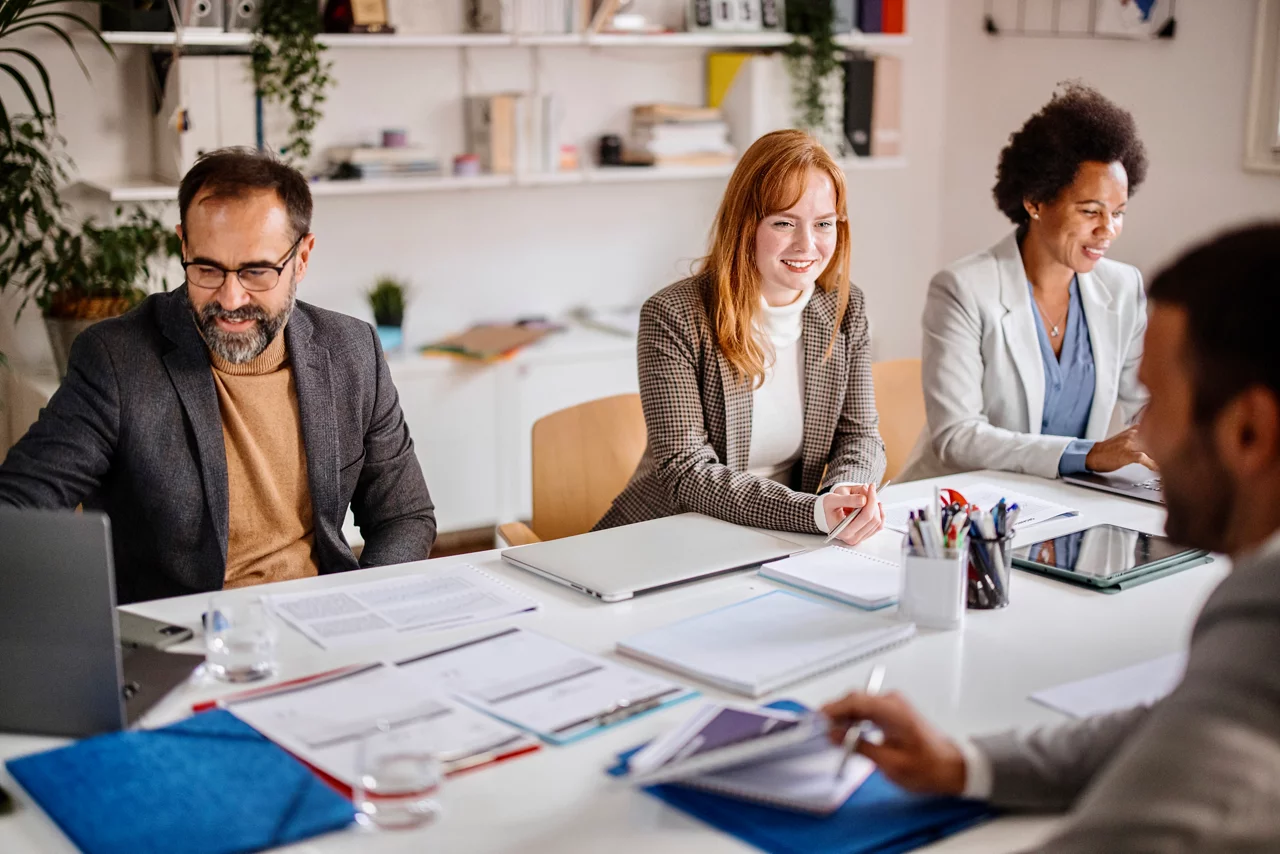 Team of corporate professionals having discussion in a meeting in conference room.