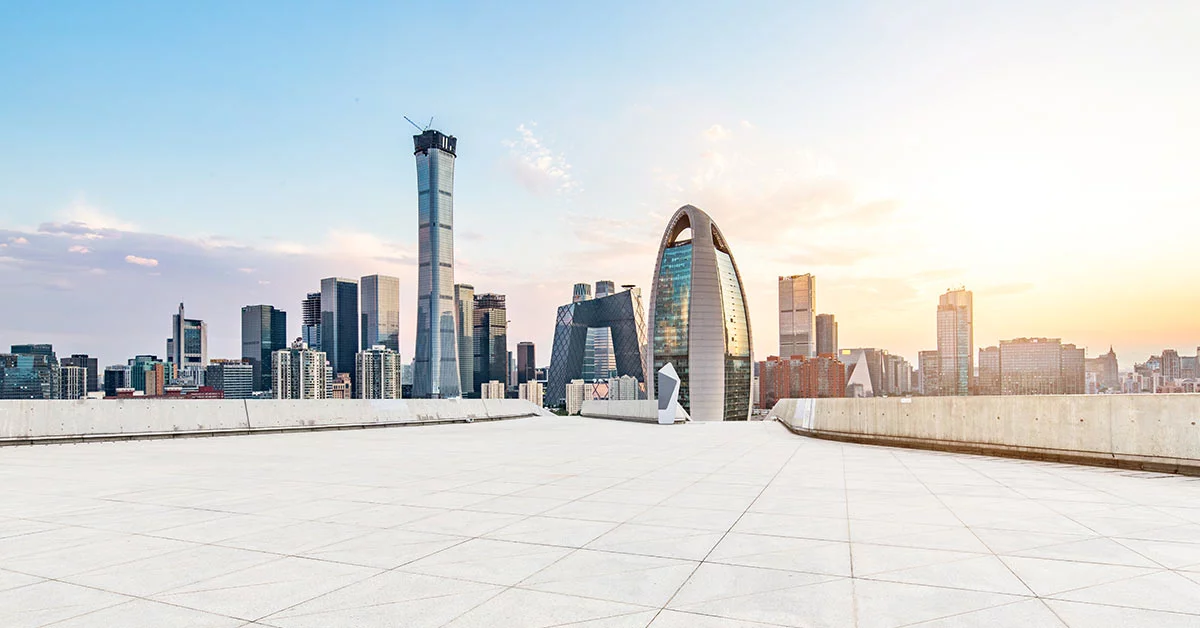 A man walks on a pristine white floor, set against a backdrop of a bustling city skyline, representing modernity and progress.