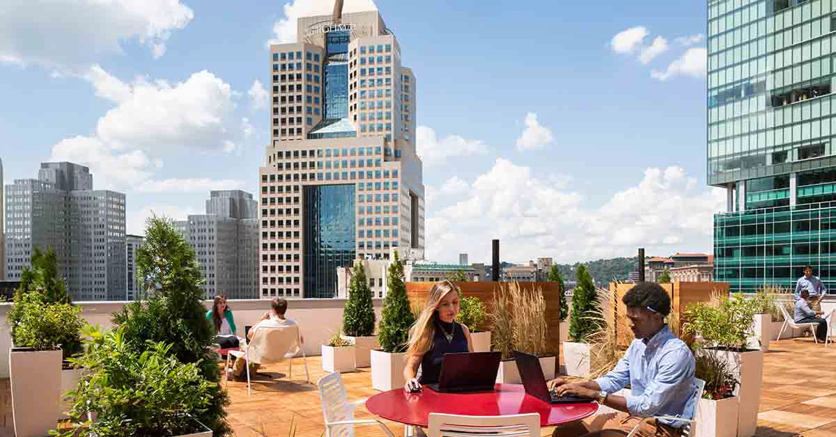 Employees working with laptop on a terrace