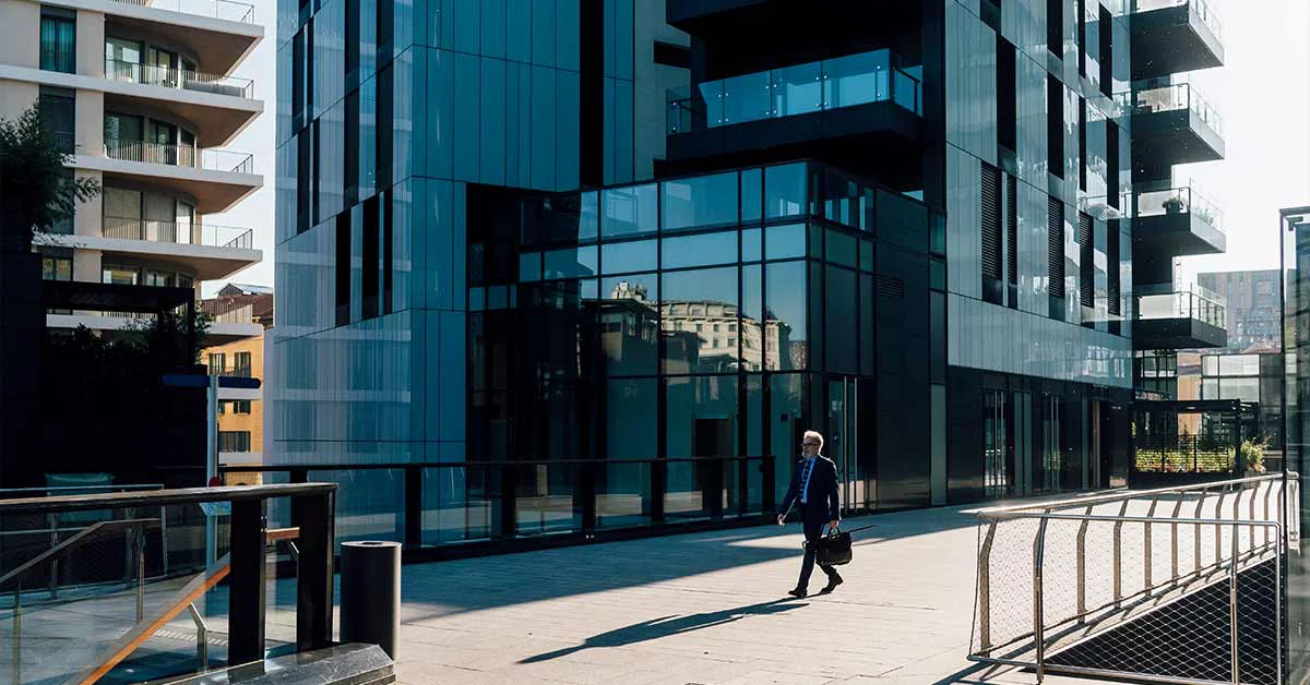 Businessman walking with-briefcase outside office