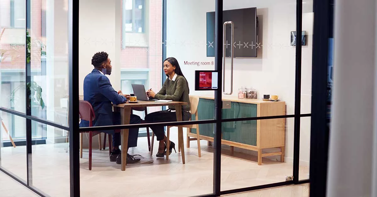 2 people in a meeting room