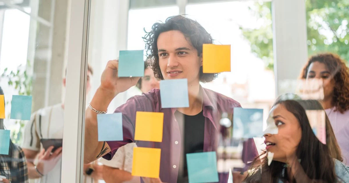 Man writing in sticky notes