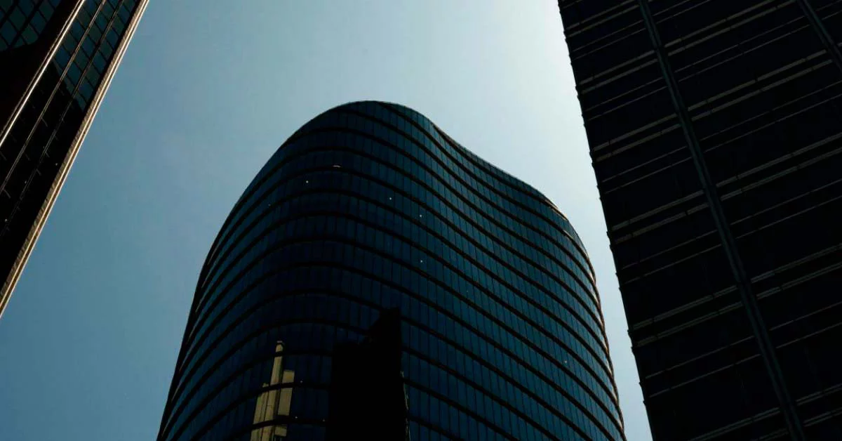 A modern skyscraper with a distinctive curved glass exterior, showcasing contemporary architectural design