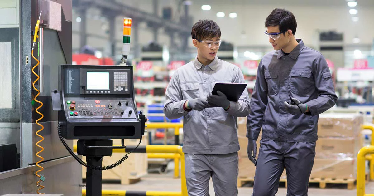 Two people on the factory floor