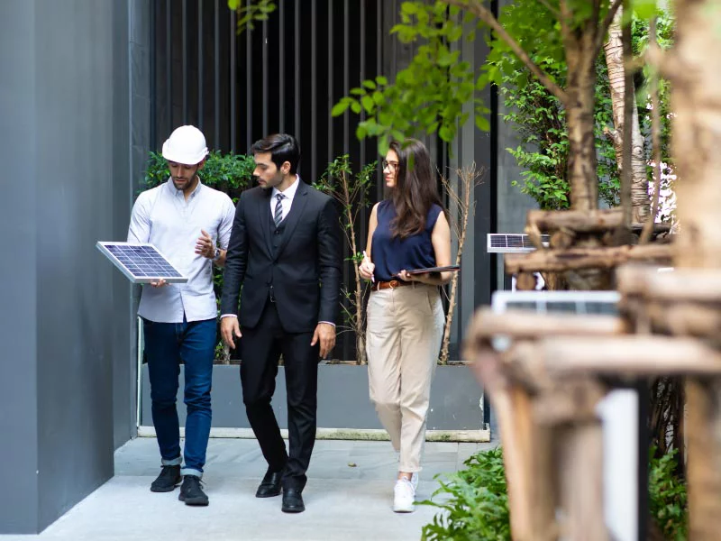 Three people walking and discussing