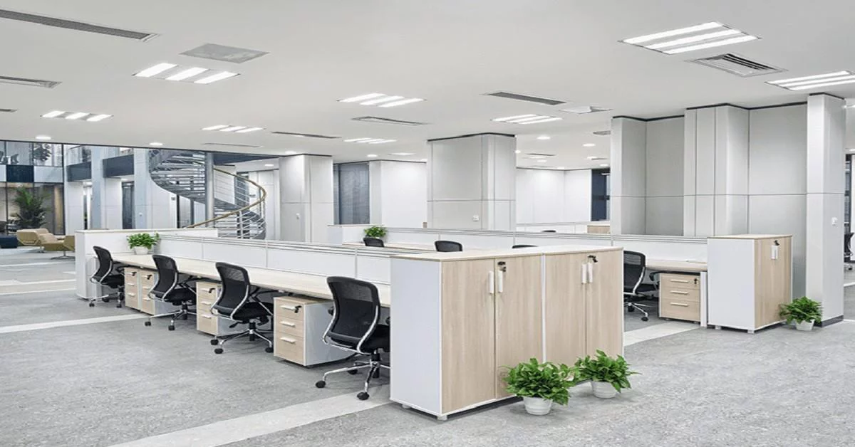  An office space featuring multiple desks and chairs arranged for work and collaboration.