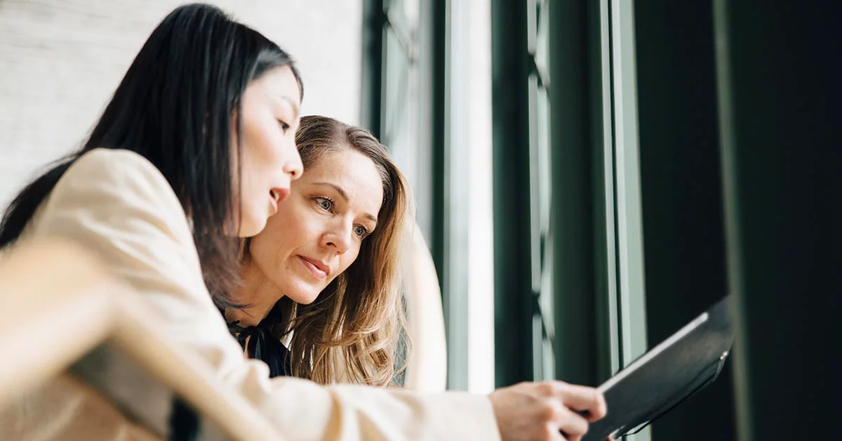 Two women looking at a document