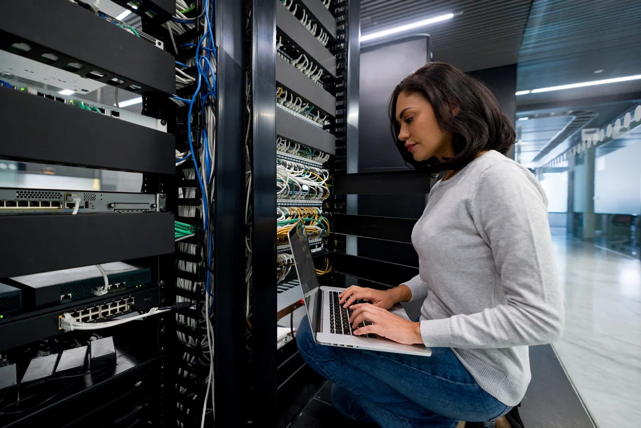 technician fixing a network server at an office