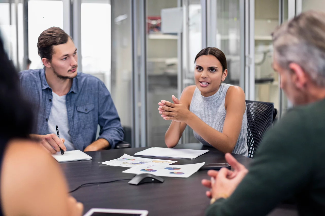 Business people on a meeting in the office, Aboriginal business woman is talking to her colleagues about the new project.