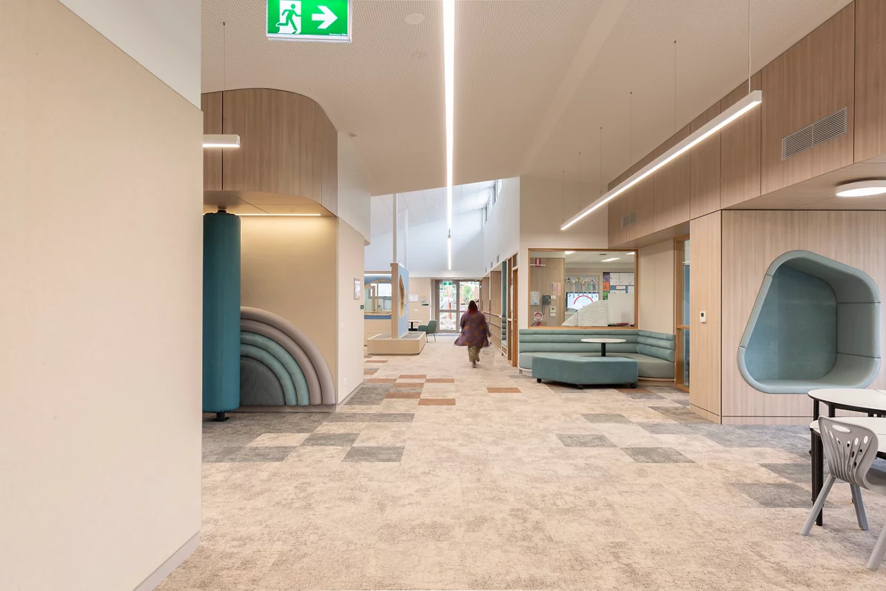 Modern office lobby with wood paneling, curved seating areas