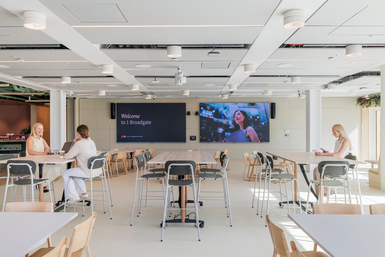 Multi-purpose café and town hall space at JLL 1 Broadgate with digital screens and flexible seating
