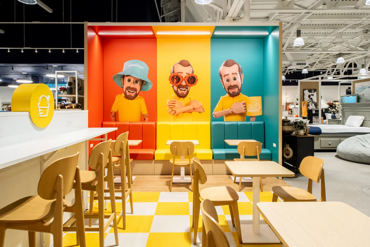 A close-up of the vibrant "Bob's Cafe" booths in a Bob's Discount Furniture store, each featuring a colorful 3D Bob mascot.