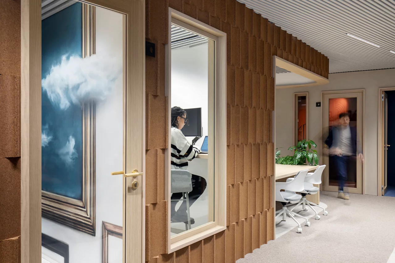 JLL colleagues in meeting room in modern  office space, furniture and greenery