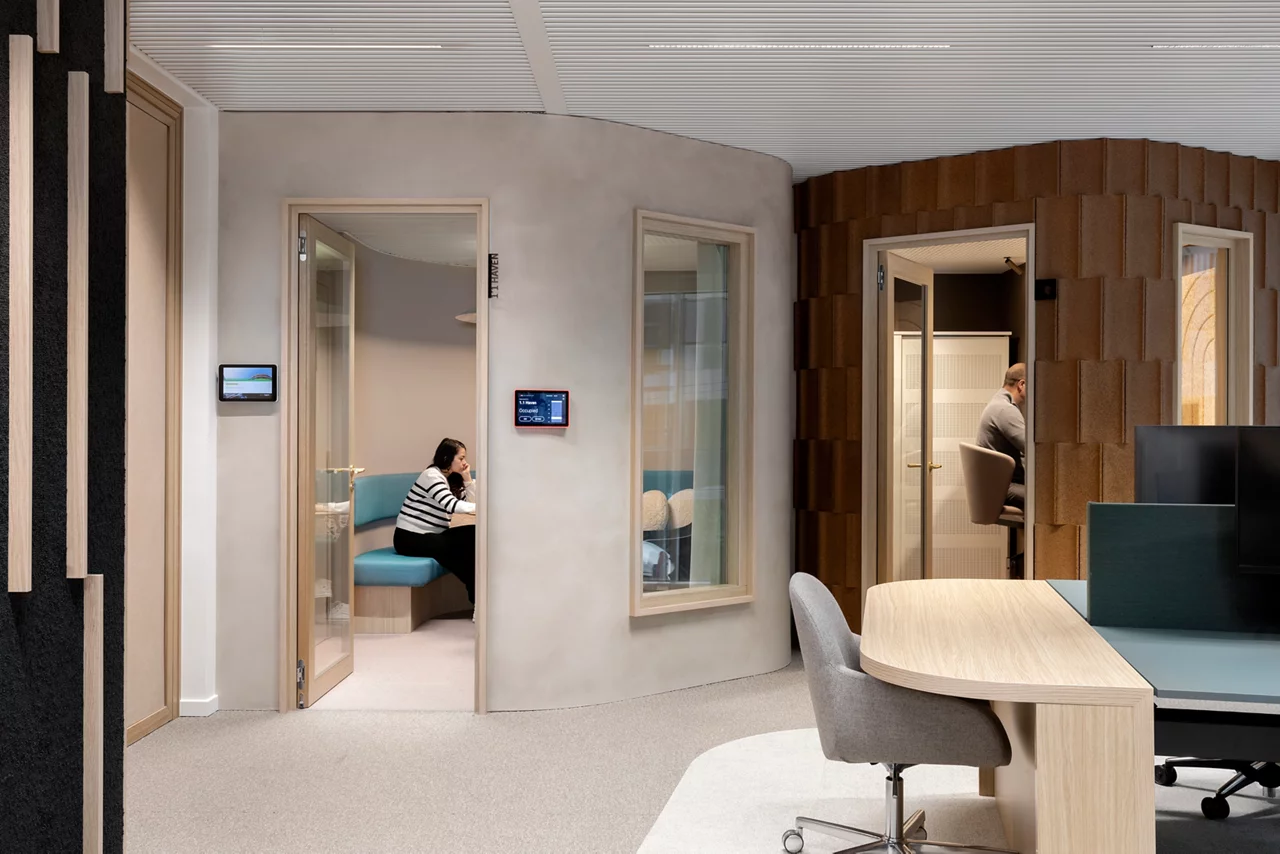 JLL colleagues in meeting room in modern  office space, furniture and greenery