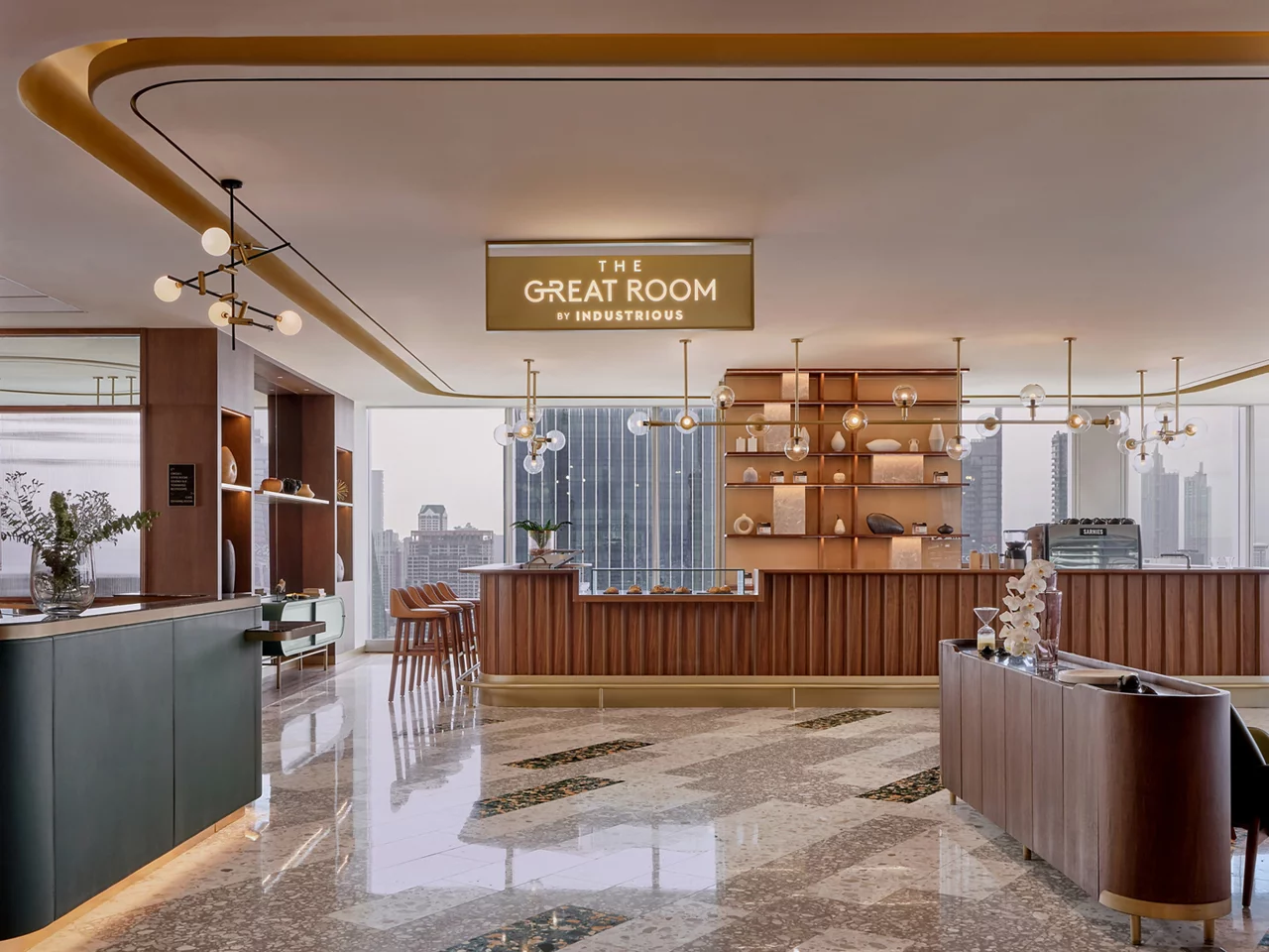 The upscale lounge of The Great Room by Industrious with a wood bar, modern lighting, and views of the city.