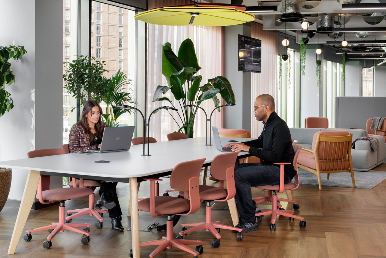 Bright and modern collaborative workspace at JLL’s Leeds office, featuring reused furniture, sustainable materials, and abundant natural light—a showcase of circular design delivering significant embodied carbon reduction.