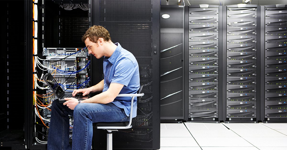 IT technician working on server rack in data center