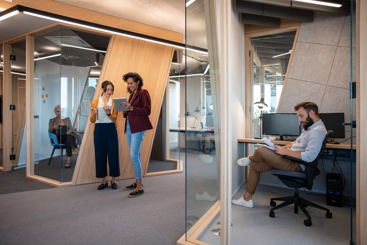 Group of happy multiracial entrepreneurs working and communicating during a meeting in person.