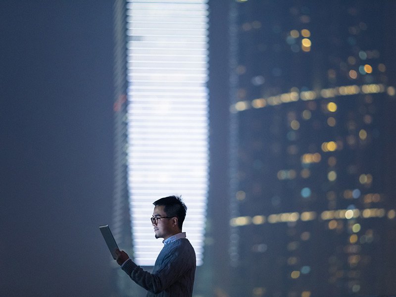 A man is working on his device