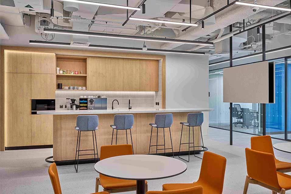 An office space featuring a modern kitchen and bar area.
