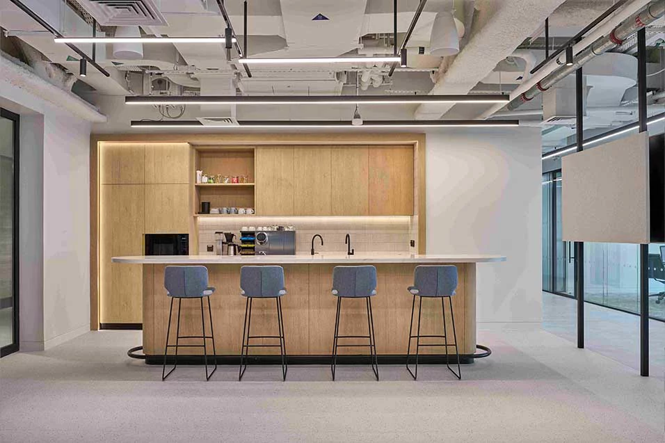 An office space featuring a modern kitchen and bar area.