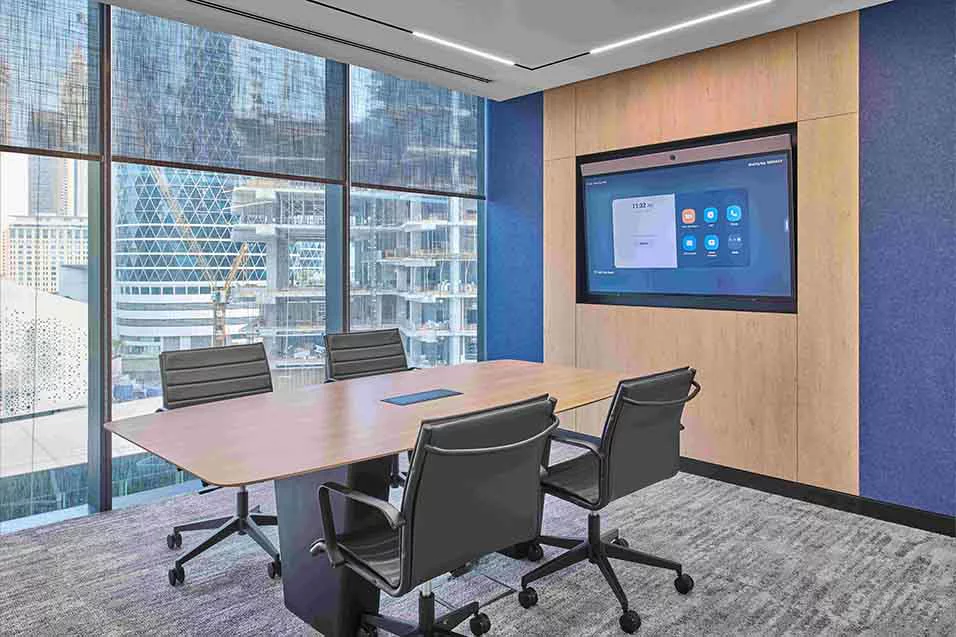 A spacious conference room equipped with a large screen