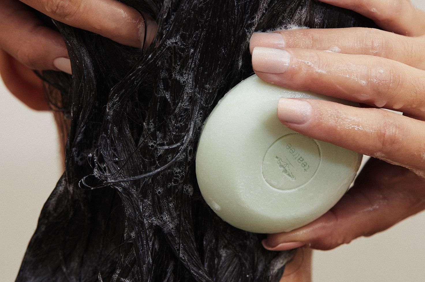 a woman using the Tea Tree Special Shampoo Bar