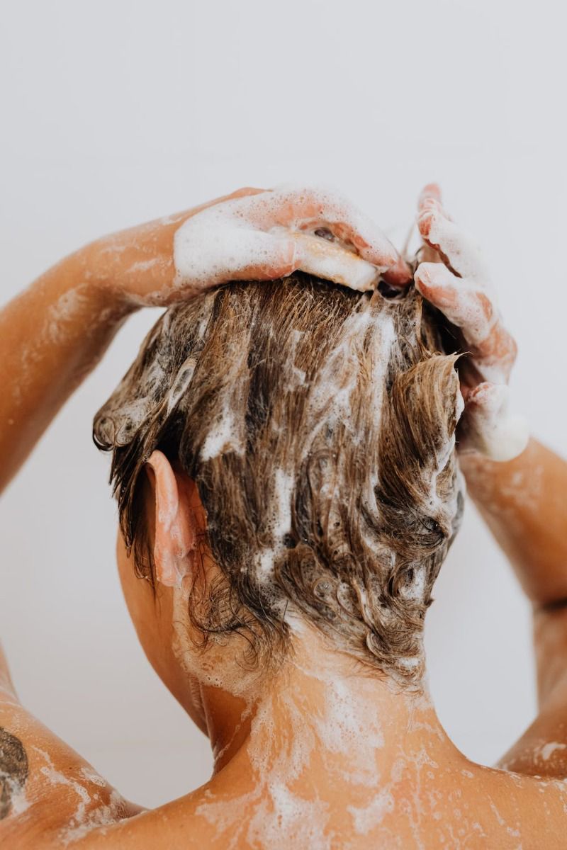 image of woman shampooing hair