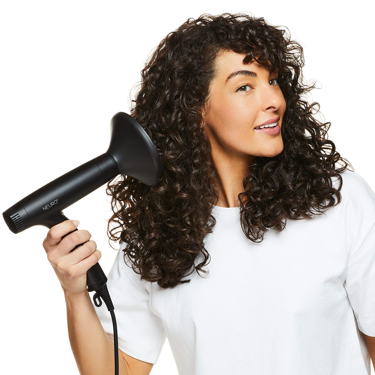 image of a brunette woman blow-drying her hair