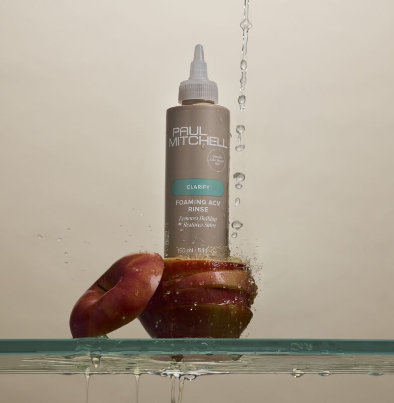 artistic image of a bottle of Paul Mitchell Foaming ACV Rinse