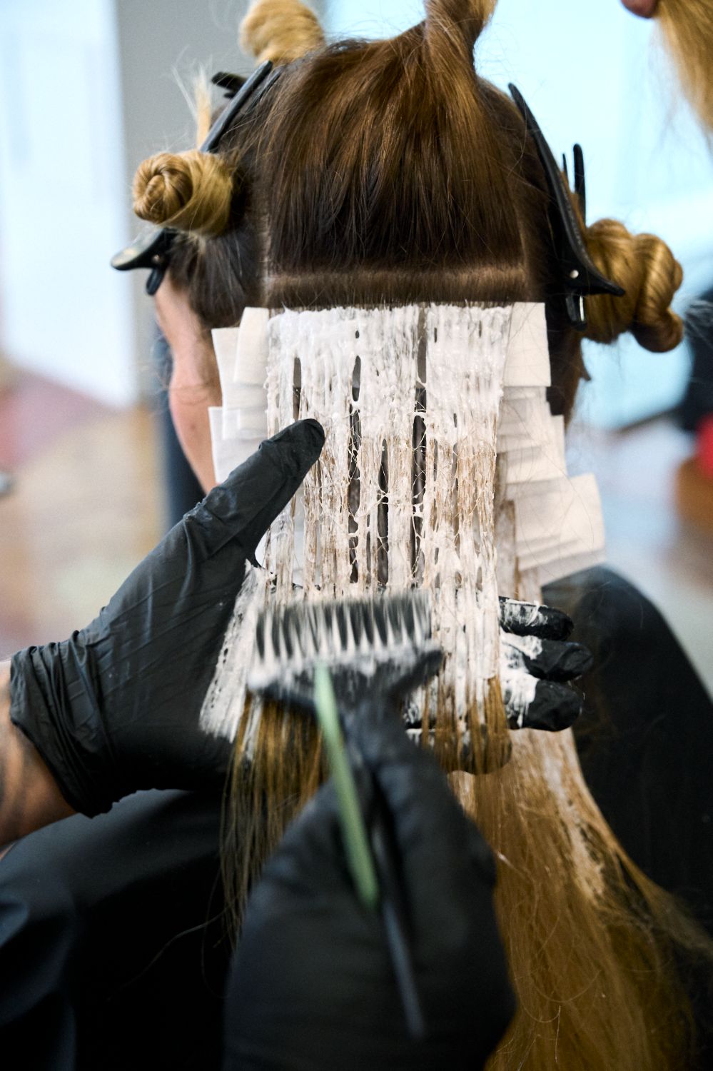 image of a woman receiving a hair lightening service